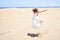 Young beautiful woman jumping crazy at maspalomas dunes beach