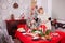 Young beautiful woman lighting candles for christmas feast