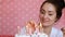 Young beautiful woman lights candles on a birthday cake. Close-up portrait