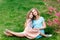 Young beautiful woman with a little daughter walking through the blooming sakura.The concept of family rest and love