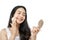 young beautiful woman with long black hair using puff to wipe powder on cheeks while holding small mirror