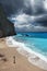 Young beautiful woman looks at the sea on the Porto Katsiki beach.