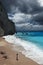 Young beautiful woman looks at the sea on the Porto Katsiki beach, Lefkada island, Greece