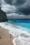 Young beautiful woman looks at the sea on the Porto Katsiki beach, Lefkada island, Greece