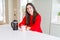 Young beautiful woman making morning coffee smiling, preparing a cup of latte for breakfast