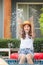 Young beautiful woman making water splash at the pool. Asian girl splash water relaxing in swimming pool. Happiness lifestyle