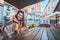 Young beautiful woman order food in outdoor cafe in chill morning