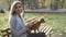 Young beautiful Woman in the park with her funny long-haired chihuahua dog. Autumn background