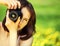 Young beautiful woman photographing in summer park