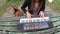 Young and beautiful woman playing synthesizer on the table of a park, France