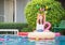 Young beautiful woman at the pool. Asian girl relaxing in swimming pool. Happiness lifestyle concepts