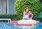 Young beautiful woman at the pool. Asian girl relaxing in swimming pool. Happiness lifestyle concepts