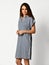 Young beautiful woman posing in new design casual spring stripped dress smiling on grey