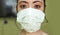 Young beautiful woman in protective face mask in prevention against Wuhan Coronavirus epidemic outbreak in China in virus transmis