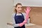 Young beautiful woman puts rubber gloves on her hands for cleaning.