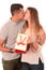 Young Beautiful Woman receiving Present and kissing handsome man