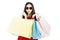 Young beautiful woman in red dress carrying color pastel shopping bag isolated banner white background with copy space