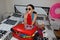 Young beautiful woman, red suitcase, sitting, waiting, summer vacation, colorful, traveling around world