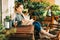 Young beautiful woman relaxing on cozy balcony, reading a book