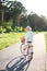 Young beautiful woman riding a bicycle in a park. Active people. Outdoors relax