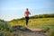 Young Beautiful Woman Running on the Mountain Trail in the Hot Summer Evening. Sport and Active Lifestyle