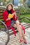 Young beautiful woman sitting on a bench in autumn Park