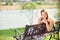 Young beautiful woman sitting on bench in park pretty girl at outdoors on summer day nature. attractive girl in park sitting on be