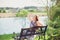 Young beautiful woman sitting on bench in park pretty girl at outdoors on summer day nature. attractive girl in park sitting on be