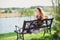 Young beautiful woman sitting on bench in park pretty girl at outdoors on summer day nature. attractive girl in park sitting on be