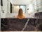 young beautiful woman is sitting in black marble bath