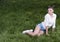 Young beautiful woman sitting on the lawn waiting