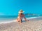 Young beautiful woman is sitting on the sea cost and enjoying waves landscape. Alanya, Turkey