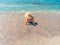 Young beautiful woman is sitting on the sea cost and enjoying waves landscape. Alanya, Turkey