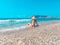 Young beautiful woman is sitting on the sea cost and enjoying waves landscape. Alanya, Turkey