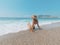 Young beautiful woman is sitting on the sea cost and enjoying waves landscape. Alanya, Turkey