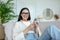 Young beautiful woman sitting on the sofa and looking at the camera