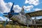 Young beautiful woman stands on an abandoned plane