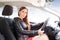 Young beautiful woman steering wheel driving a car