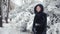 Young beautiful woman in stylish mink coat on a background of a winter park