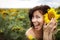 Young beautiful woman in a sunflower field. Summer picnic