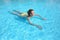 Young beautiful woman swimming in paddling pool