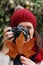 Young beautiful woman takes pictures to beech leaves in one of the most amazing beech forest in Europe, La Fageda d\'en Jorda.