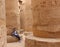 Young beautiful woman taking pictures between the columns of the hypostyle hall of Karnak\'s temple in Luxor, Egypt