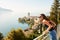 Young beautiful woman tourist admiring amazing view of Montreux city, Switzerland