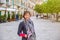 Young beautiful woman traveler with black jacket looking at camera, smile and posing in Matera city historical centre