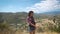A young beautiful woman using extreme camera at incredible landscapes in Cyprus. Awesome view from the top of the