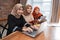 Young beautiful woman veiled smiling looking the camera when sitting with laptop, tablet, and book