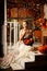 Young beautiful woman in vintage dress on autumn porch. Beauty g