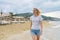 Young beautiful woman walking along evening beach