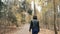 Young Beautiful Woman Walking In Autumn Park. Girl Walking In Forest In Fall, Lifestyle Concept